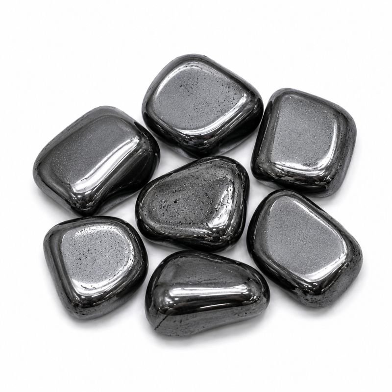 Natural polished Hematite Tumble Stone with smooth metallic gray to black surface on a white background