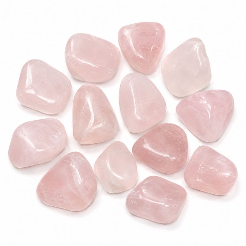 Natural polished Rose Quartz Tumble Stone with soft pink color and smooth finish on a white backgroun