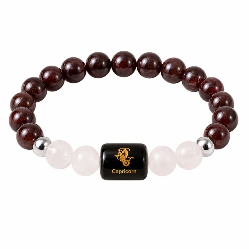 Capricorn Zodiac Bracelet featuring natural Garnet and Milky Quartz gemstone beads with a Capricorn zodiac charm symbolizing ambition, success, confidence, emotional balance, perseverance, and personal growth.
