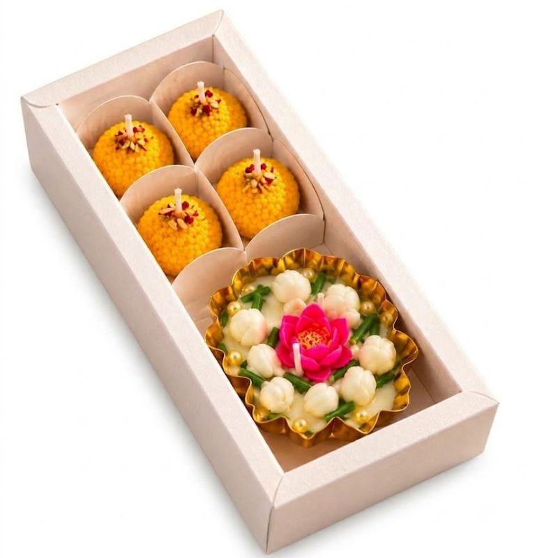 Mogra and lotus urli candle gift hamper with four yellow ladoo candles in a gift box